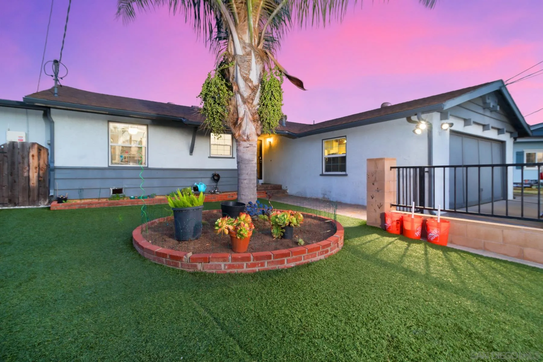 a front view of a house with a garden