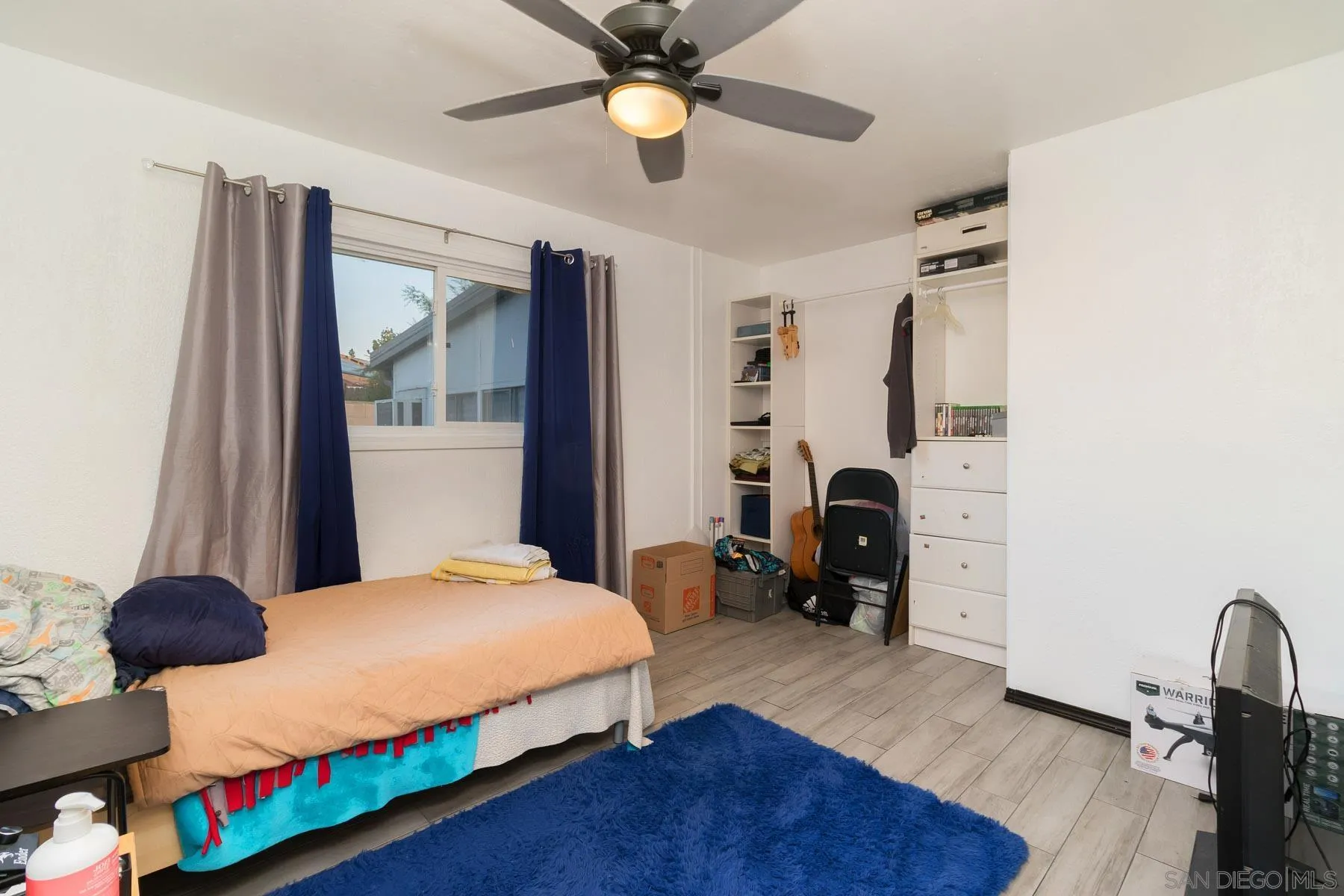 501 Thayer Drive Spring Valley, CA 91977 - Photo 12 of 20 a bedroom with a bed and a chandelier
