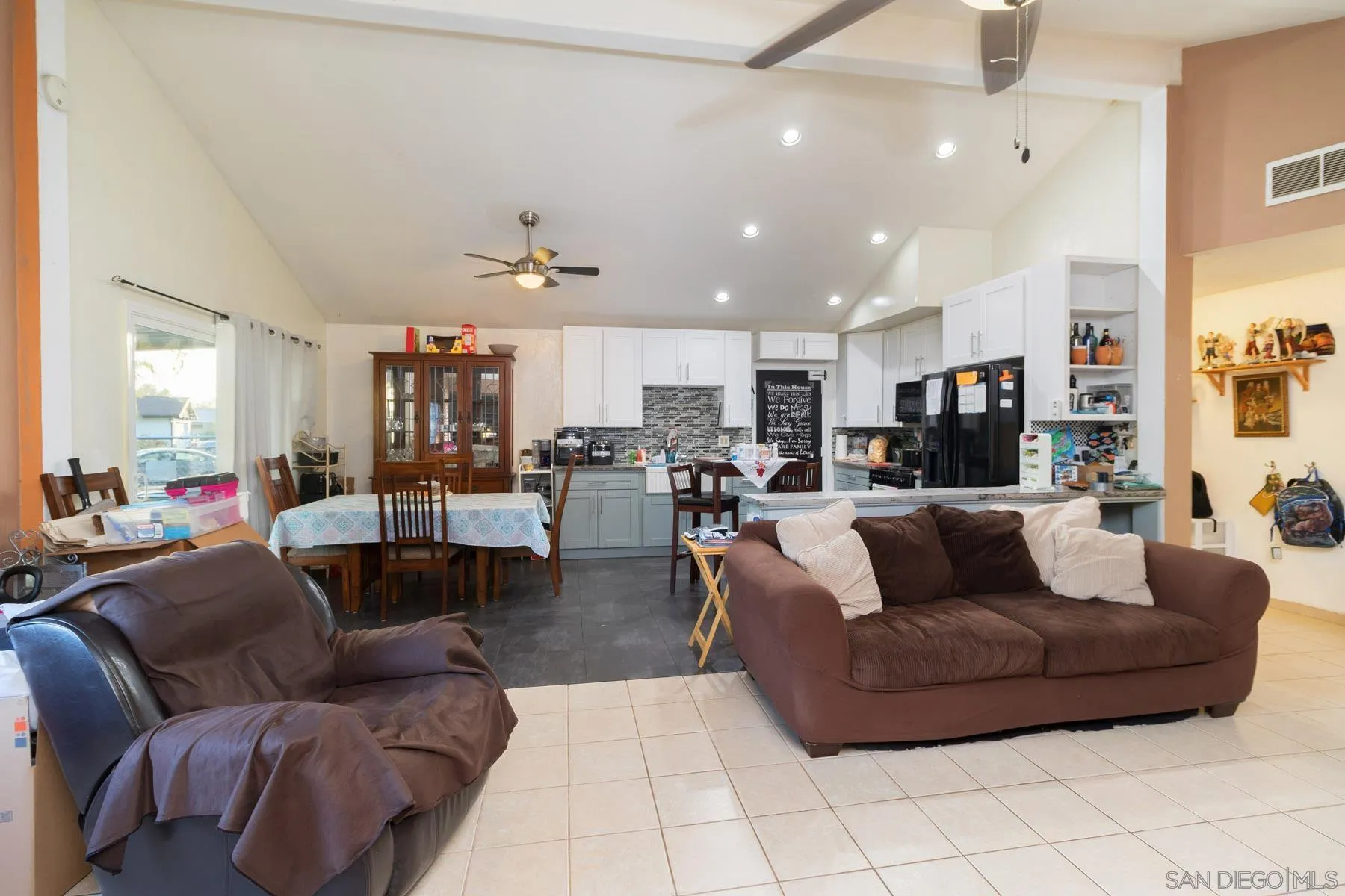 501 Thayer Drive Spring Valley, CA 91977 - Photo 3 of 20 a living room with furniture kitchen view and a chandelier