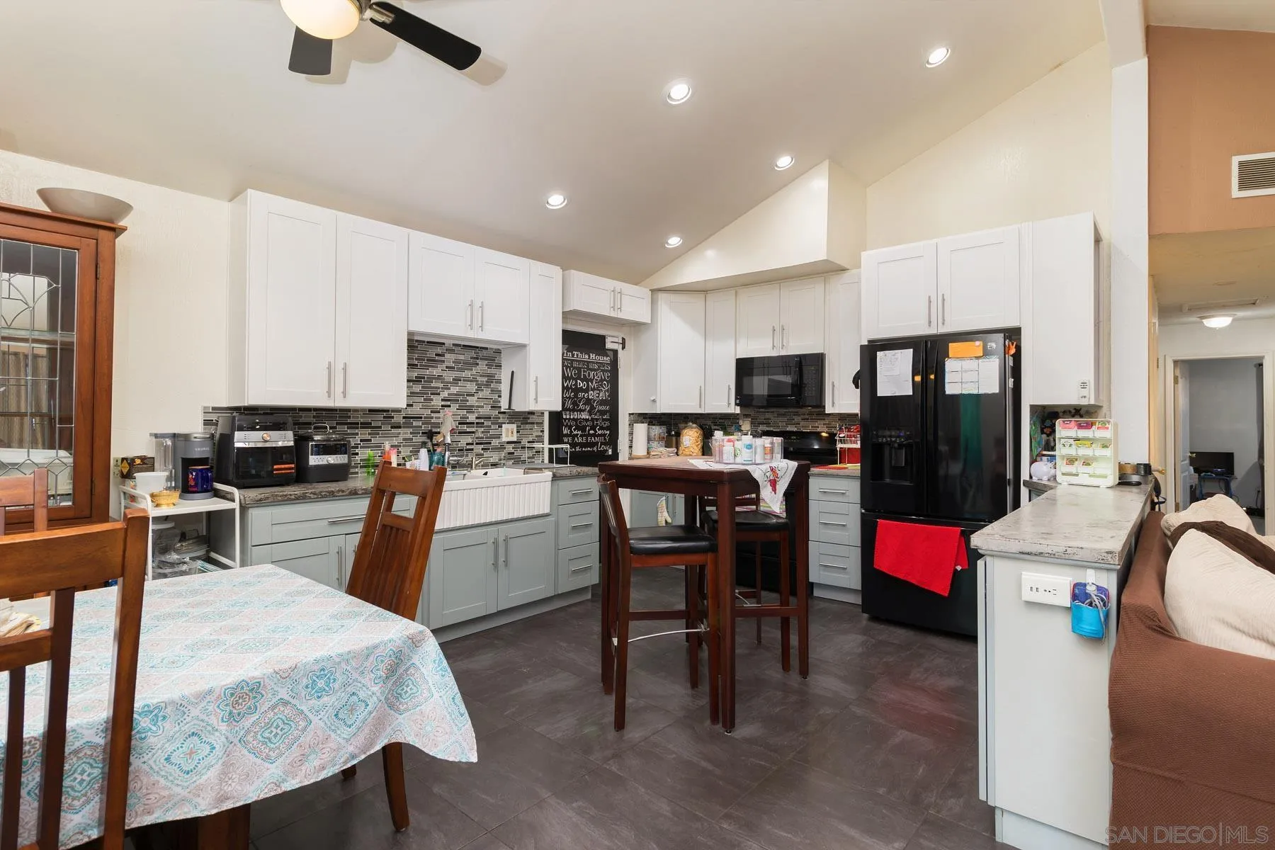 501 Thayer Drive Spring Valley, CA 91977 - Photo 4 of 20 a kitchen with sink a refrigerator and chairs