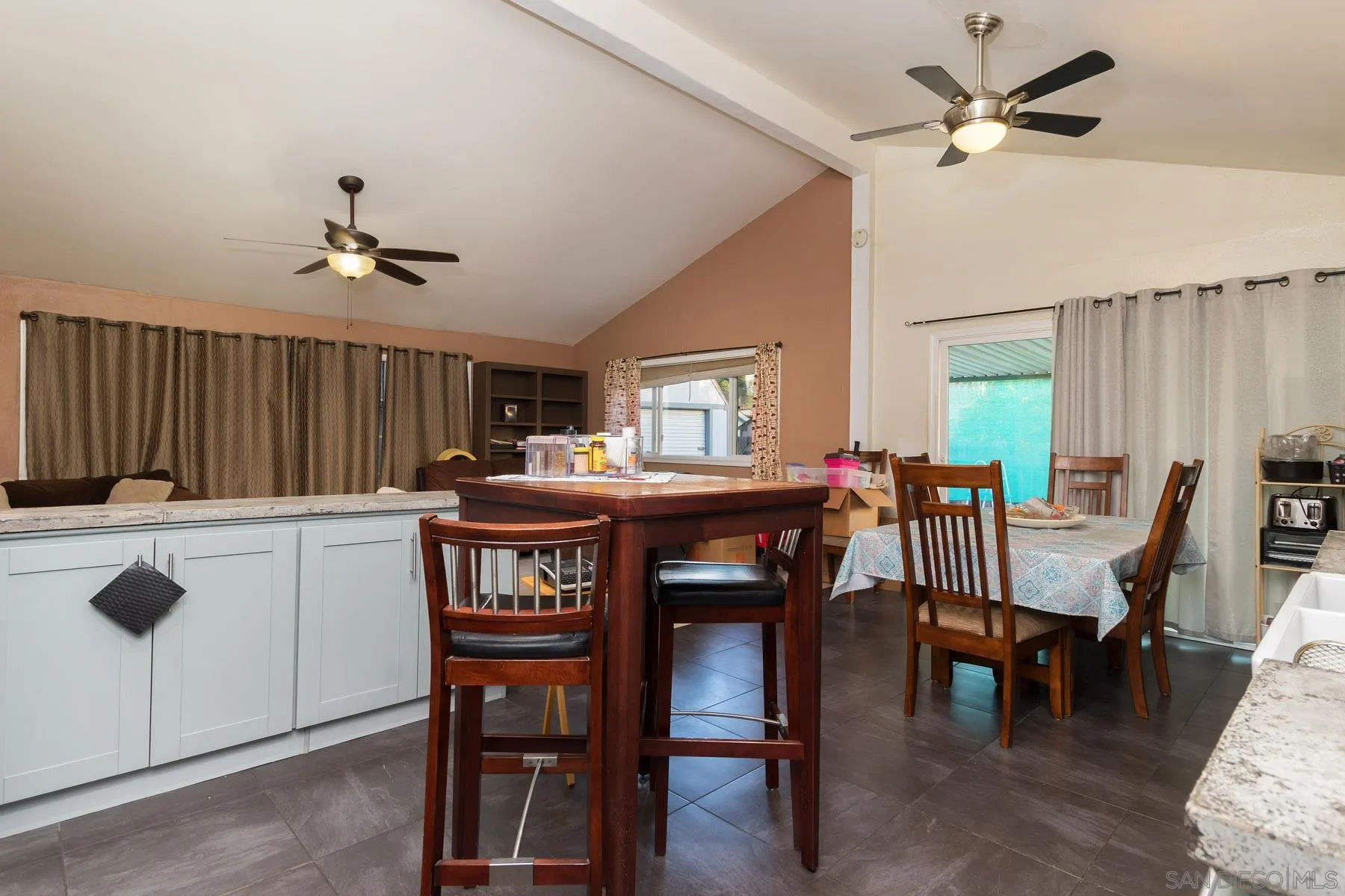 501 Thayer Drive Spring Valley, CA 91977 - Photo 5 of 20 a kitchen with a dining table chairs and white cabinets