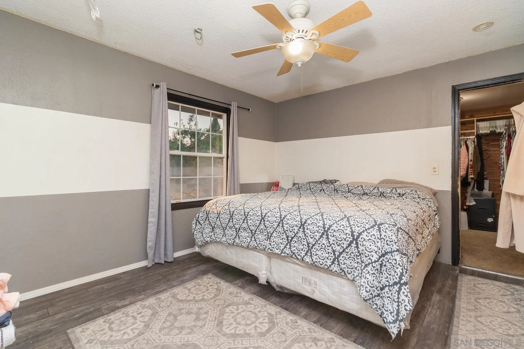 501 Thayer Drive Spring Valley, CA 91977 - Photo 10 of 20 a bedroom with a large bed and a window