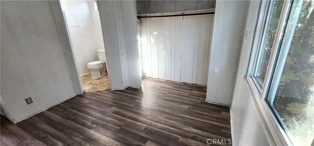a view of a room with wooden floor and a carpet