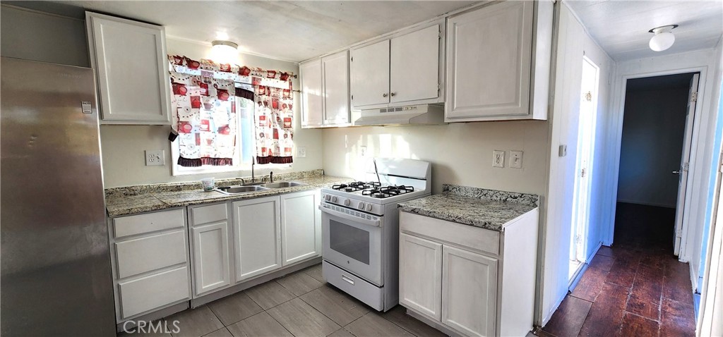 8562 C Avenue, Unit 48 Hesperia, CA 92345 - Photo 18 of 37 a kitchen with stainless steel appliances granite countertop a stove and a sink