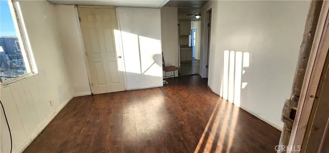 a view of a hallway with wooden floor and stairs