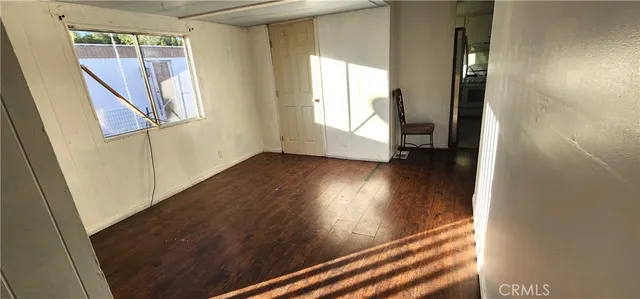 an entryway with wooden floor and stairs