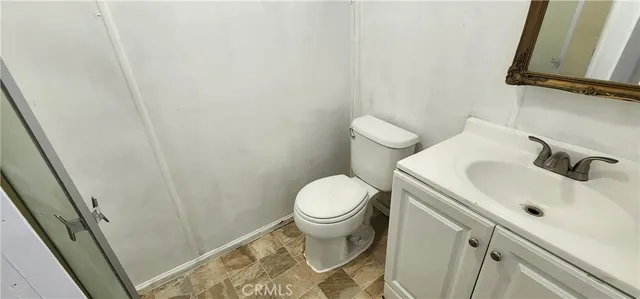 a white toilet sitting next to a bathroom sink