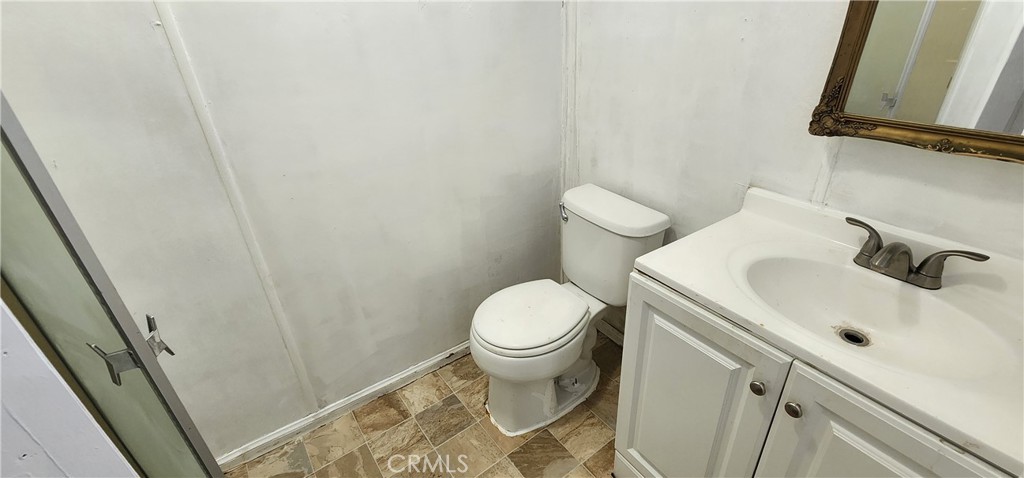 8562 C Avenue, Unit 48 Hesperia, CA 92345 - Photo 27 of 37 a white toilet sitting next to a bathroom sink