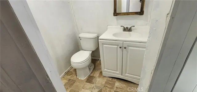 a white toilet sitting next to a white sink