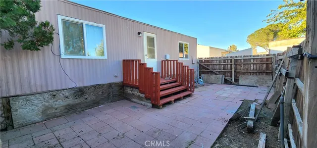 a view of a backyard with a wooden fence
