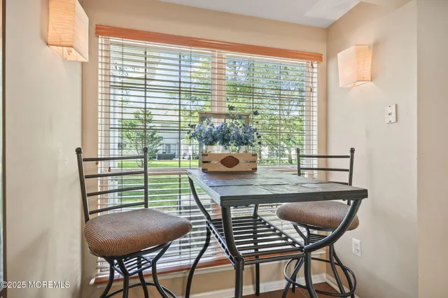 a view of a dining room with furniture and window