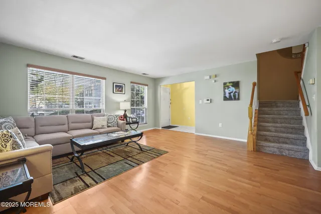 a living room with furniture and wooden floor