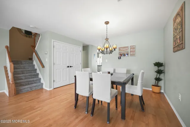 a view of a dining room with furniture wooden floor and staircase