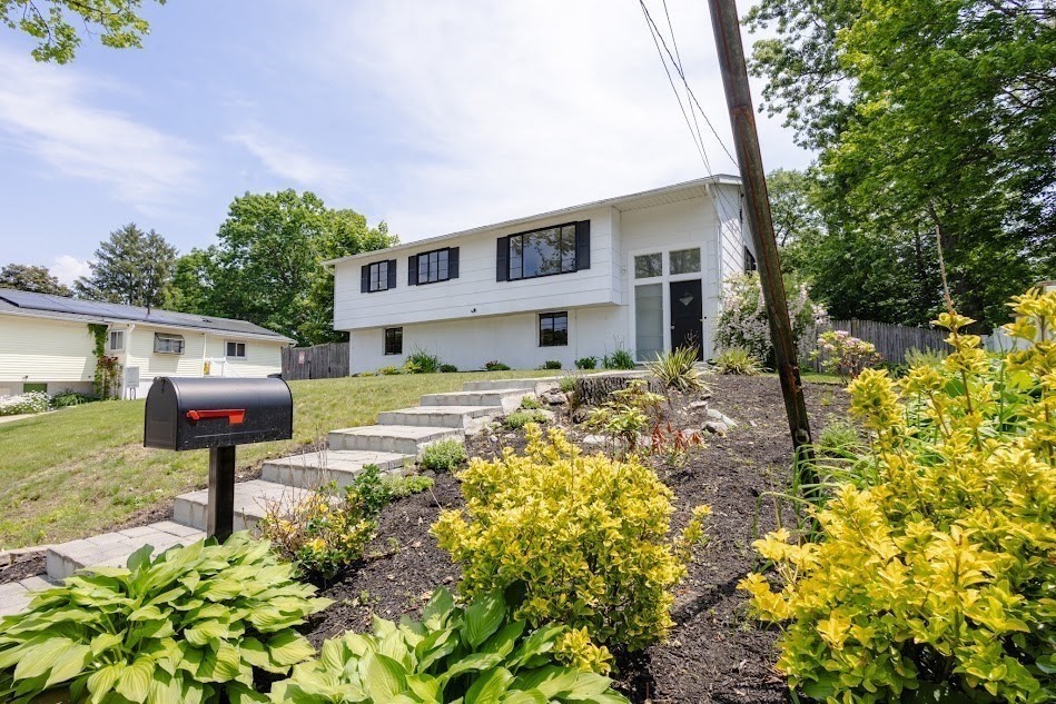 a front view of a house with garden
