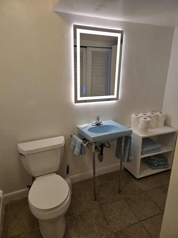 30 Leighton Road Boston, MA 02136 - Photo 15 of 38 a bathroom with a toilet a sink and a window