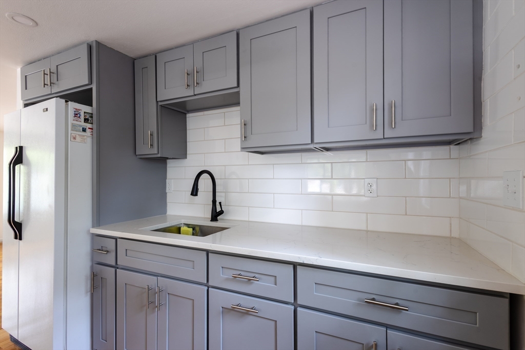 30 Leighton Road Boston, MA 02136 - Photo 18 of 38 a kitchen with stainless steel appliances granite countertop a sink a refrigerator and cabinets