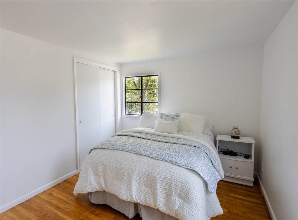 30 Leighton Road Boston, MA 02136 - Photo 32 of 38 a bed sitting in a bedroom next to a window