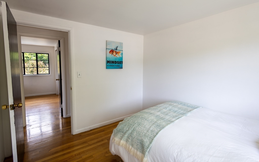 30 Leighton Road Boston, MA 02136 - Photo 33 of 38 a bedroom with a bed and wooden floor