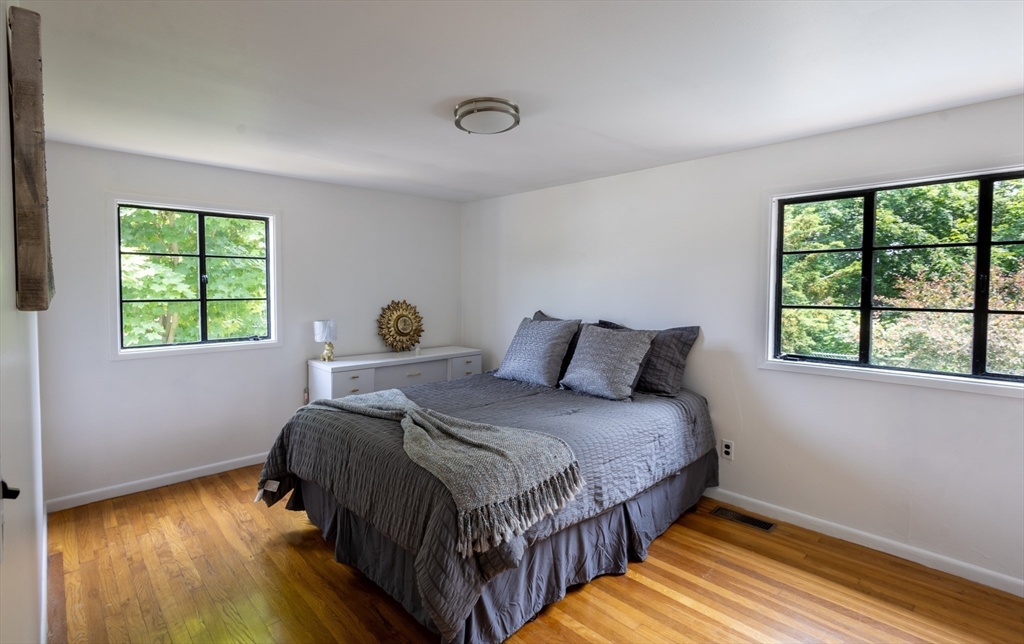 30 Leighton Road Boston, MA 02136 - Photo 36 of 38 a bedroom with a bed a window and flowerpot