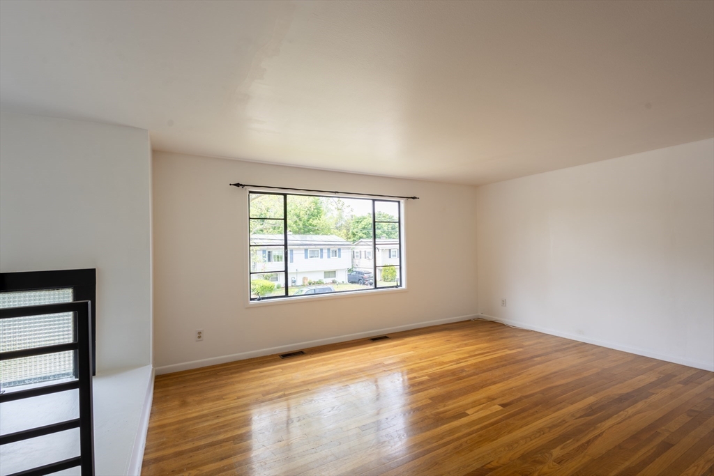 30 Leighton Road Boston, MA 02136 - Photo 7 of 38 a view of an empty room with wooden floor and a window