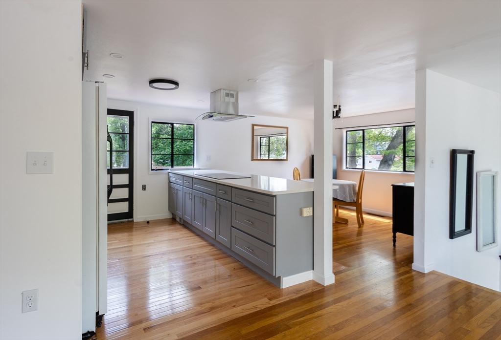 30 Leighton Road Boston, MA 02136 - Photo 10 of 38 a kitchen with stainless steel appliances granite countertop a refrigerator a sink a stove and white cabinets with wooden floor