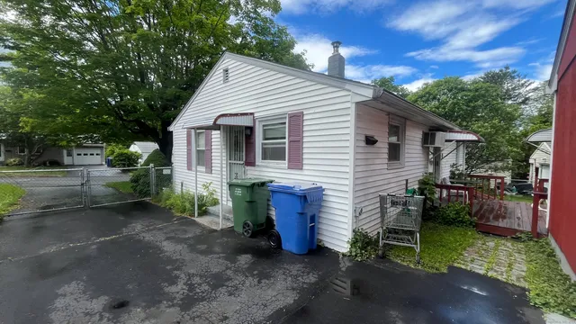 a view of a house with backyard and sitting area