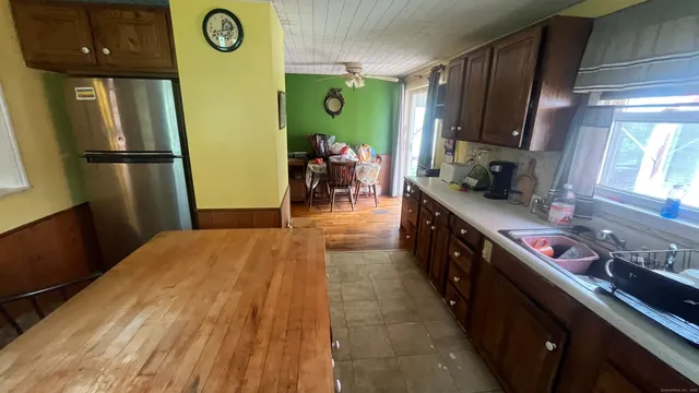 a kitchen with stainless steel appliances granite countertop a refrigerator a stove top oven a sink and dishwasher