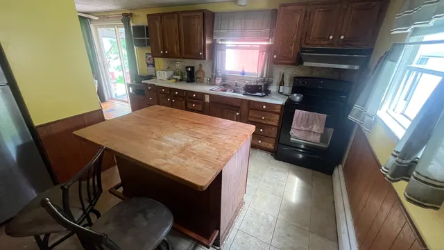 a kitchen with sink cabinets and wooden floor