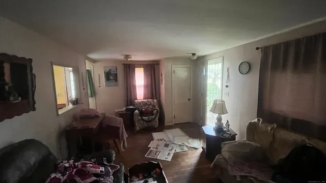 a living room with furniture and a large mirror