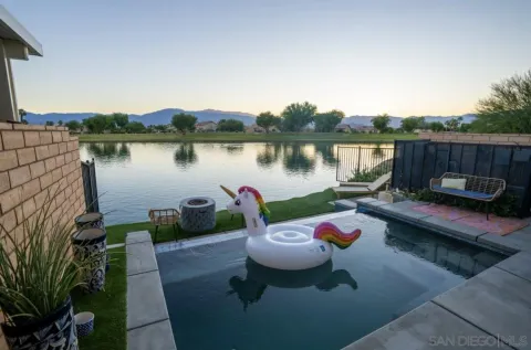 a view of a lake with a table and chairs