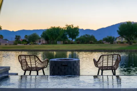 a view of a lake with couches and wooden floor