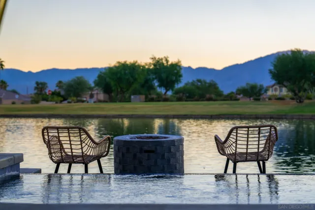 a view of a lake with couches and wooden floor