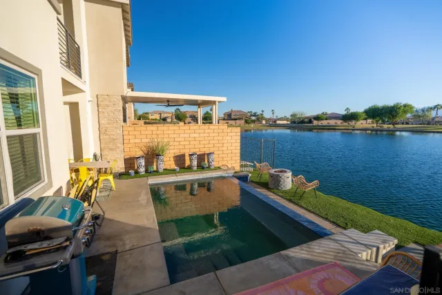a view of a balcony with chair and wooden floor