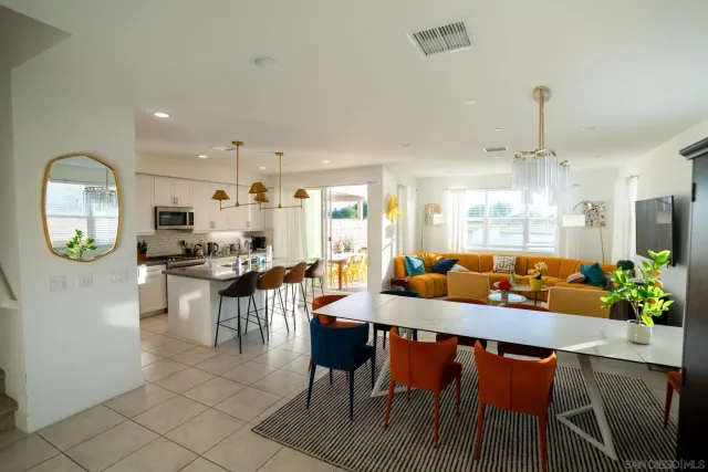 a view of a dining room with furniture and a chandelier