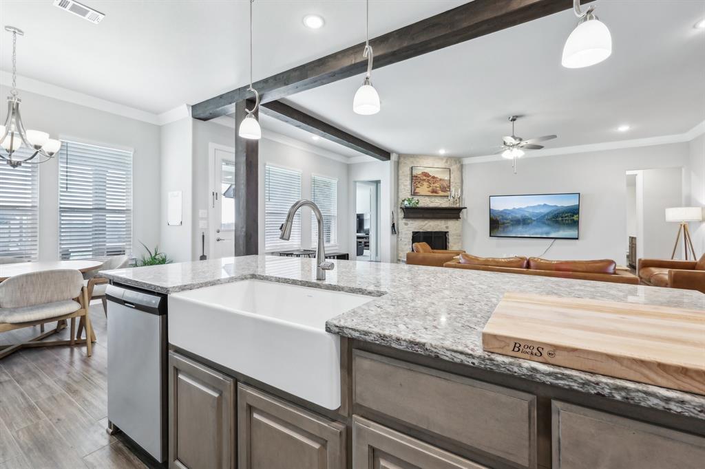 800 Majors Road Van Alstyne, TX 75495 - Photo 40 of 40 Kitchen with visible vents, a sink, stainless steel dishwasher, open floor plan, and a fireplace