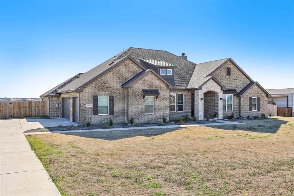 800 Majors Road Van Alstyne, TX 75495 - Photo 2 of 40 View of front of property featuring fence, concrete driveway, an attached garage, a front yard, and brick siding