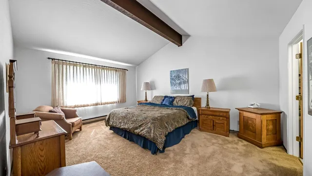 a spacious bedroom with a bed and window