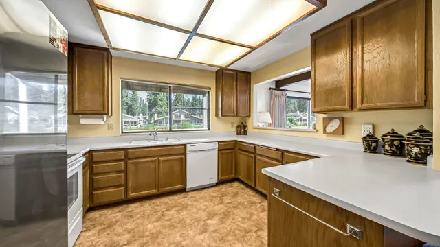 a kitchen with a sink a stove and cabinets