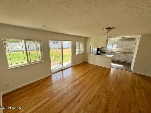 a kitchen with wooden floors and wooden cabinets