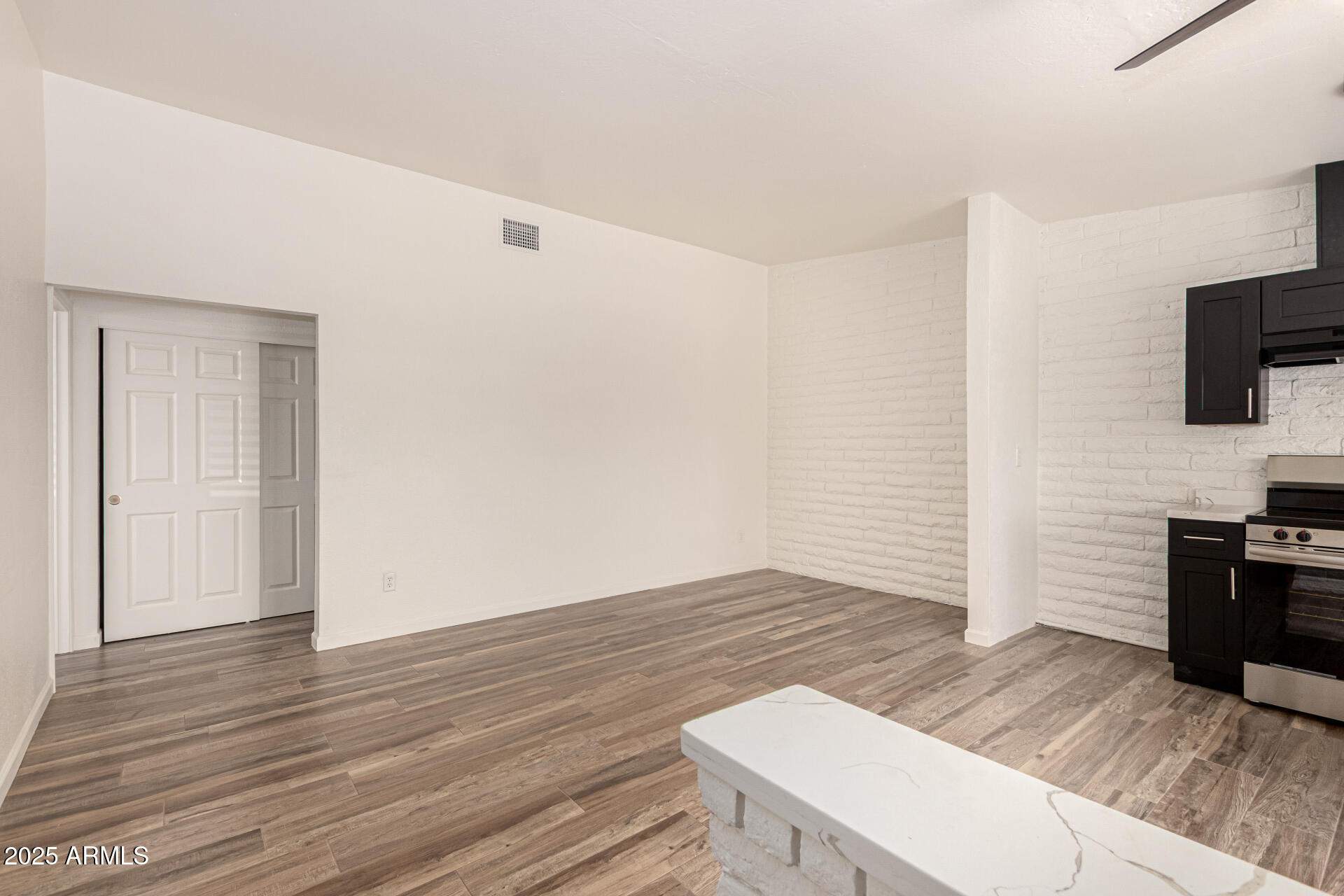 5946 West Rose Lane, Unit C Glendale, AZ 85301 - Photo 4 of 19 a view of a livingroom with wooden floor and a flat screen tv