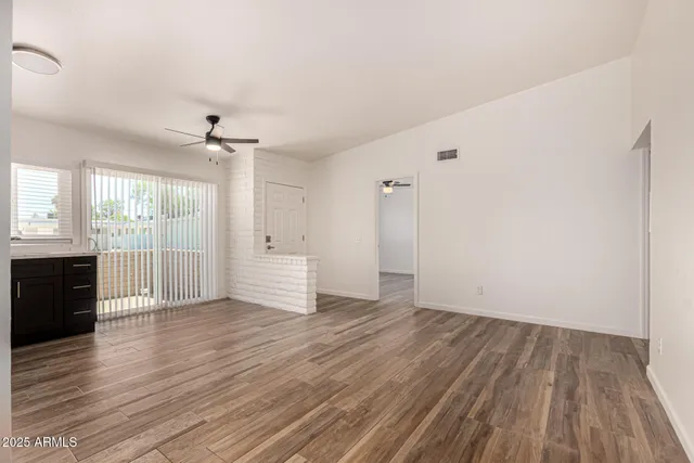 wooden floor in an empty room with a window