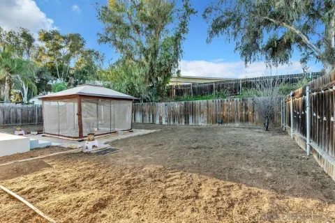 a backyard of a house with barbeque oven