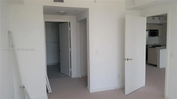 a view of a kitchen from the hallway