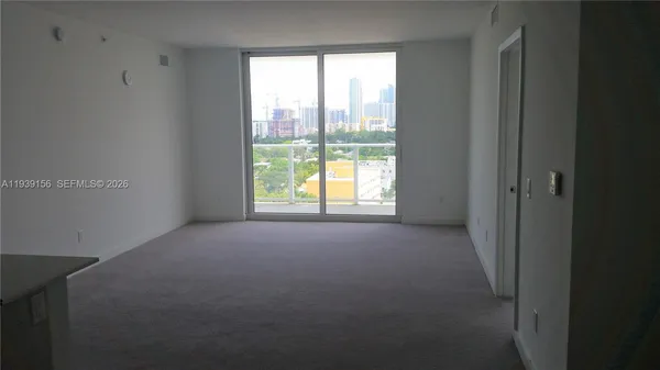 a view of an empty room with a window