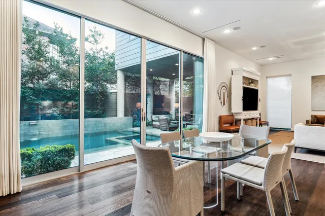 a view of a dining room with furniture wooden floor and garden view