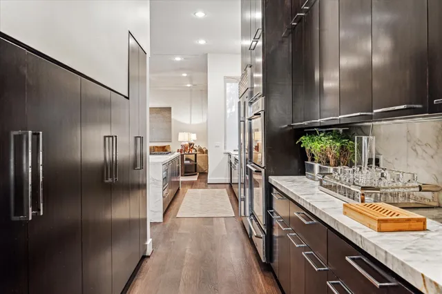 a kitchen with stainless steel appliances granite countertop a refrigerator and a sink