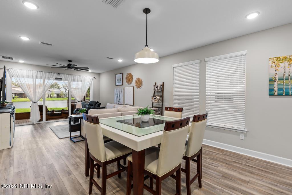 11232 Bright Path Jacksonville, FL 32256 - Photo 17 of 78 a view of a dining room with furniture window and wooden floor
