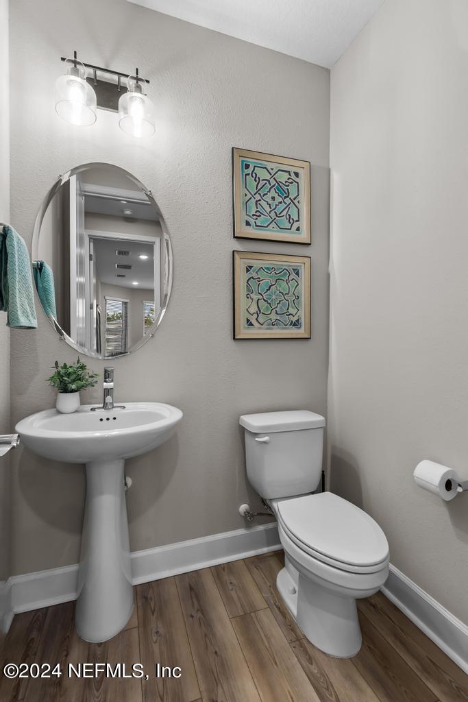 11232 Bright Path Jacksonville, FL 32256 - Photo 26 of 78 a bathroom with a toilet a sink and mirror