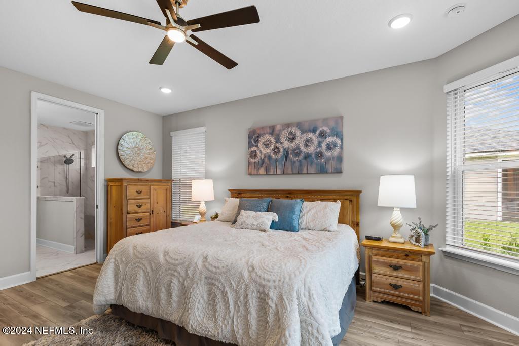 11232 Bright Path Jacksonville, FL 32256 - Photo 28 of 78 a bedroom with a bed and a chandelier