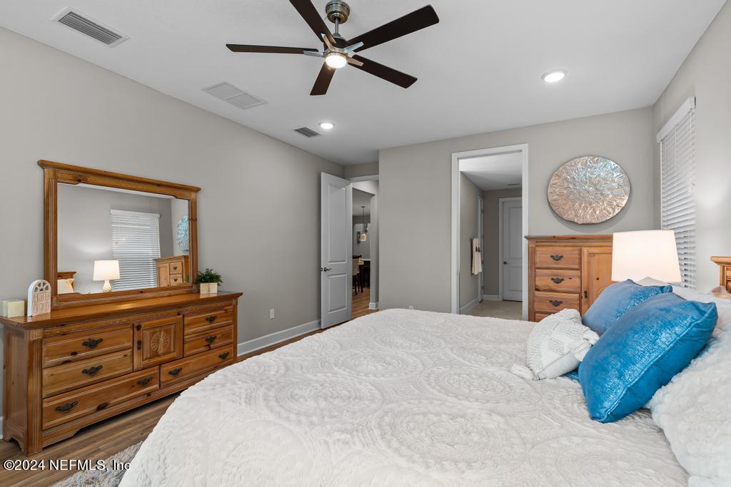 11232 Bright Path Jacksonville, FL 32256 - Photo 29 of 78 a bedroom with a bed a mirror on dresser and a large mirror